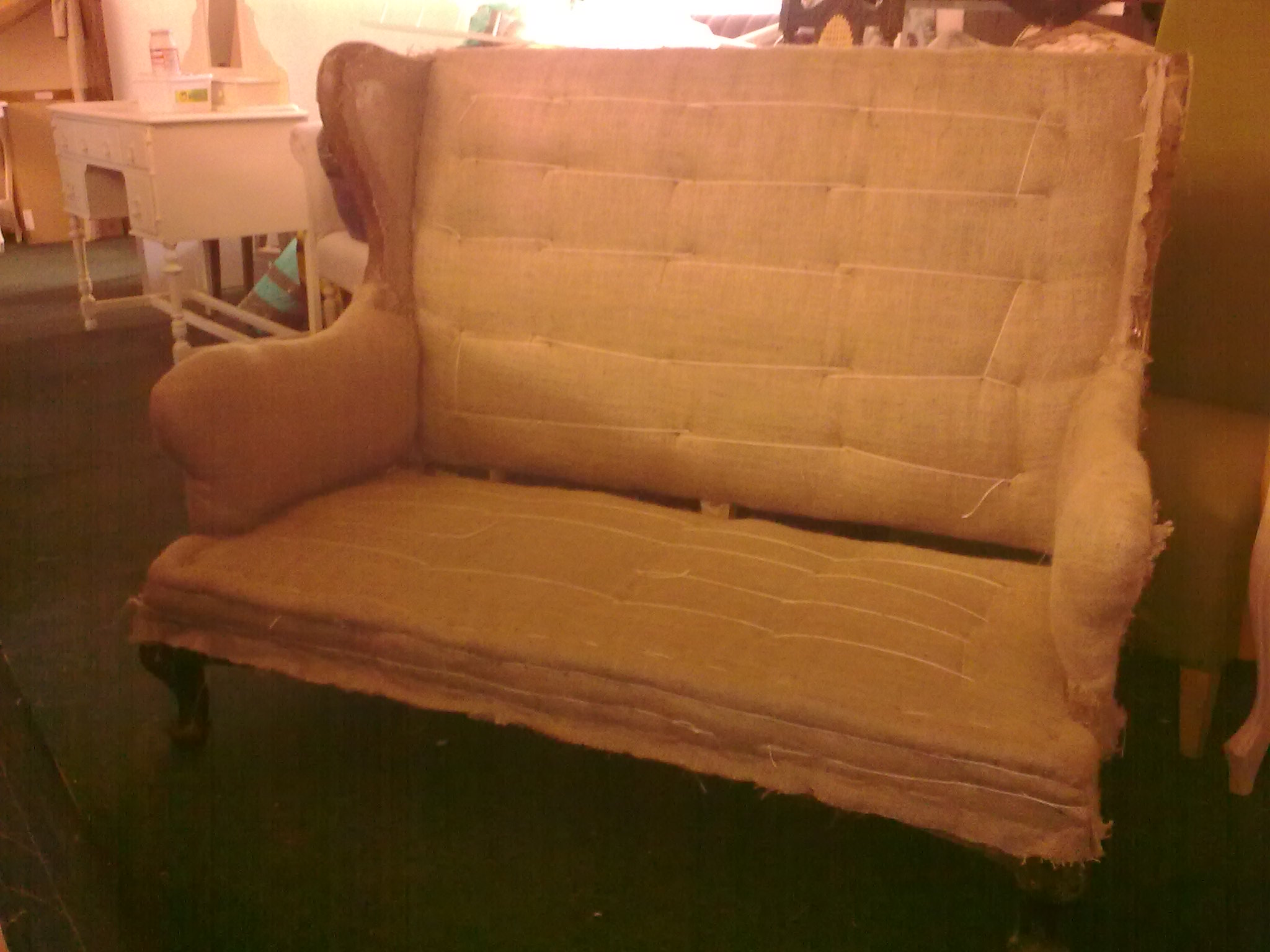 A Georgian wing Sofa. Before